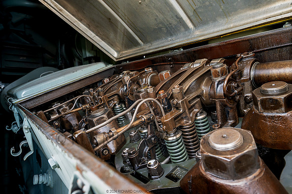 Open valve covers expose the rocker arms.